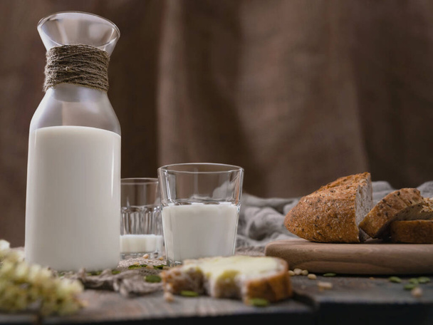 Rustic breakfast with milk and bread. World Milk Day on the first of June. Horizontal shot. - Fotó, kép
