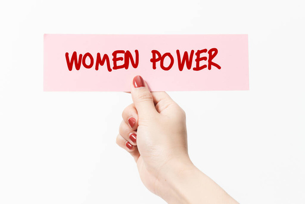 Close up women holding pink paper with WOMEN POWER text on white background. Feminist concept. - Fotoğraf, Görsel