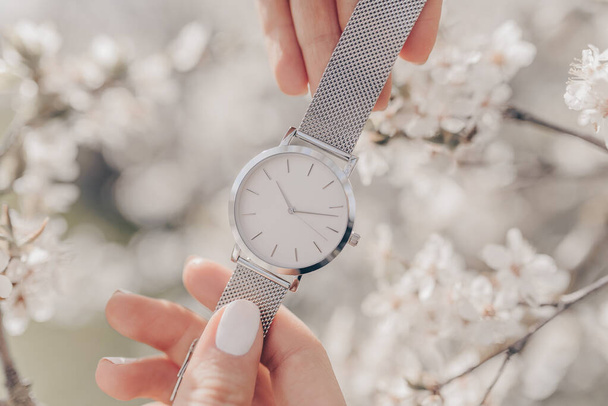 Stylish white watch in woman hands - Foto, afbeelding
