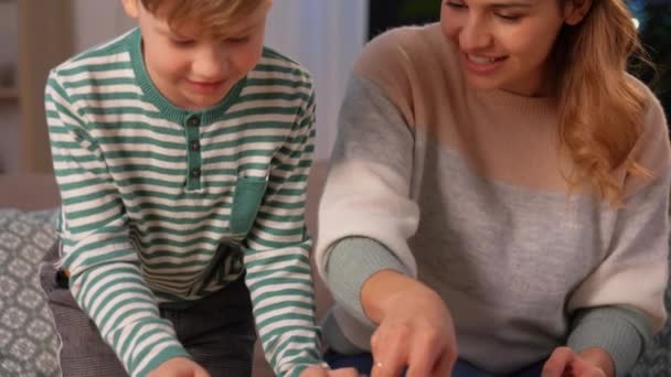 mother and son playing with toy cars at home - Záběry, video