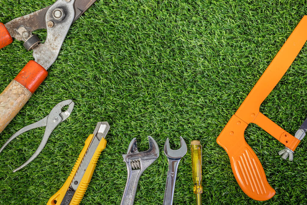 Labor day concept with construction repair tools on grass background. Space for text. - Photo, Image
