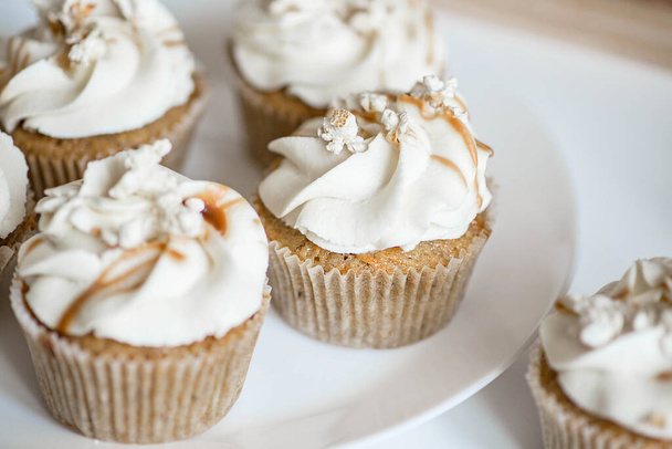 Beautiful white cupcakes on a white plate. - Fotografie, Obrázek