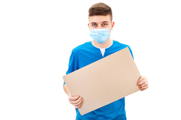 Young Man in Flu Mask hold a Blank Board Isolated on the White Background - Zdjęcie, obraz