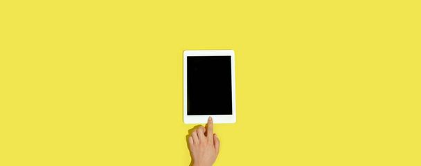 Hand using gadgets, device on top view, blank screen with copyspace, minimalistic style, flyer - Zdjęcie, obraz