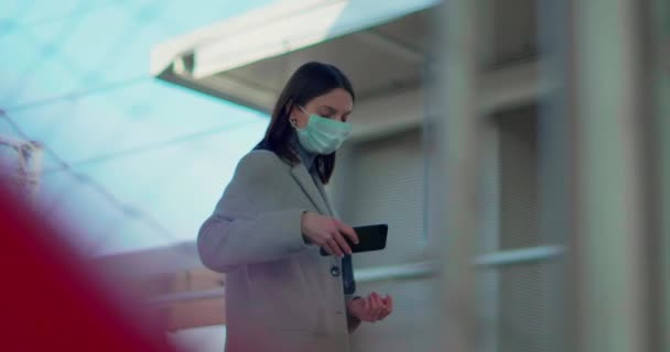 Woman with protective mask checking phone - Video