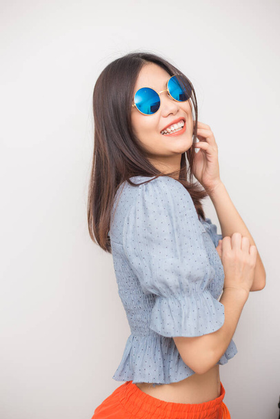 Portrait of fashion beautiful asian women with sunglasses posting on white background - Foto, Imagen