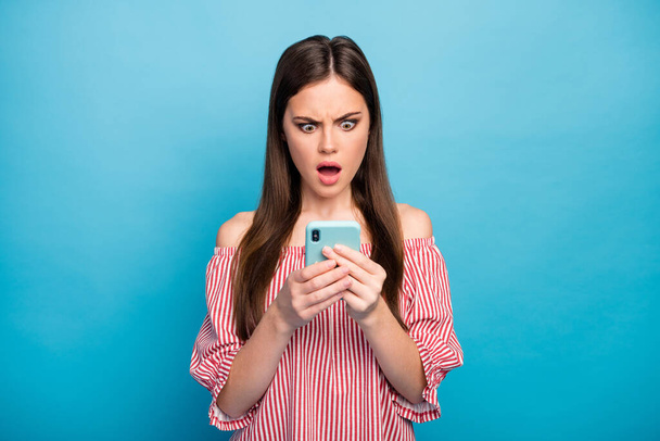Close-up portrait of her she nice attractive lovely pretty stunned outraged long-haired girl using cell smm dislike reaction isolated over bright vivid shine vibrant blue color background - Фото, зображення