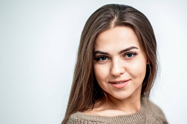 Portrait of beautiful caucasian young woman with perfect hairstyle and makeup on white background. - 写真・画像