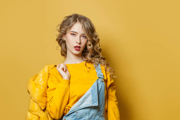 Young woman on bright yellow background - Photo, Image