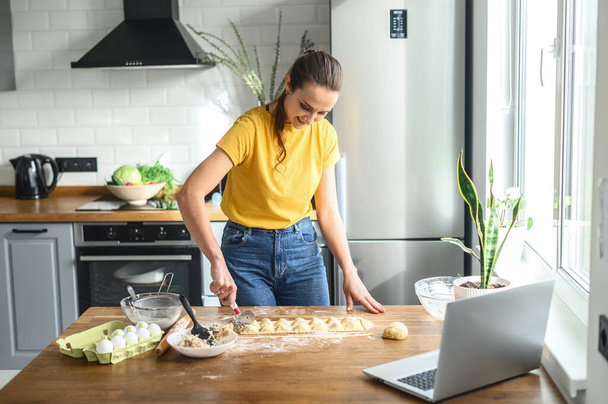 Woman watching video recipes and preparing food - Фото, зображення