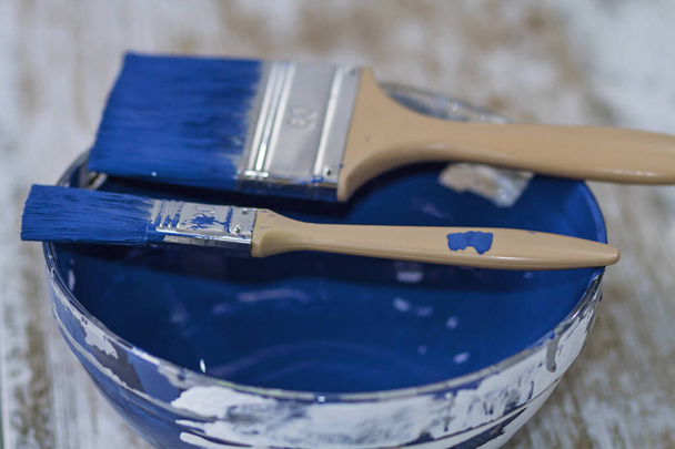 A bowl with intense chalk paint and brushes - Photo, Image