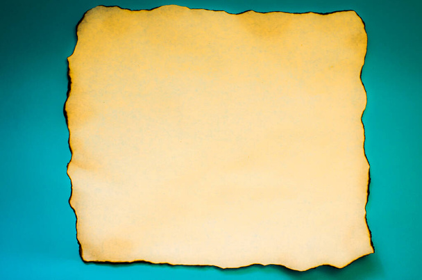 A piece of old paper on a blue background with place for your text. The structure of the old paper. - Photo, Image