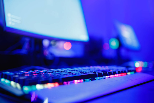 Gamer espacio de trabajo streamer profesional con monitor de ordenador. Campeonato de deporte cibernético, luces de color azul neón
 - Foto, imagen