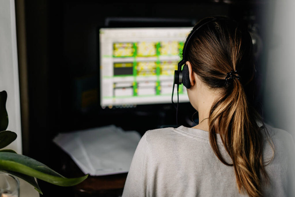 Young woman talking to customers at home online call center. An office worker who is forced to work from home due to quarantine isolation - Photo, Image