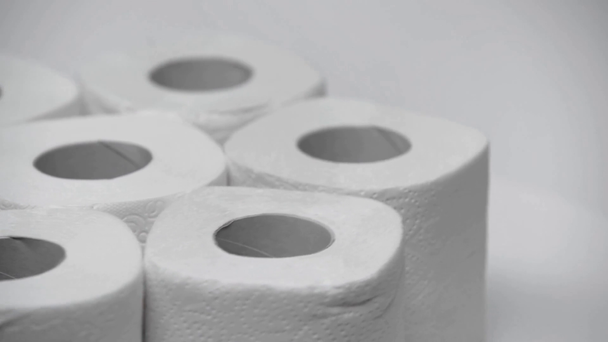 selective focus of clean and soft toilet paper rolling on white  - 映像、動画