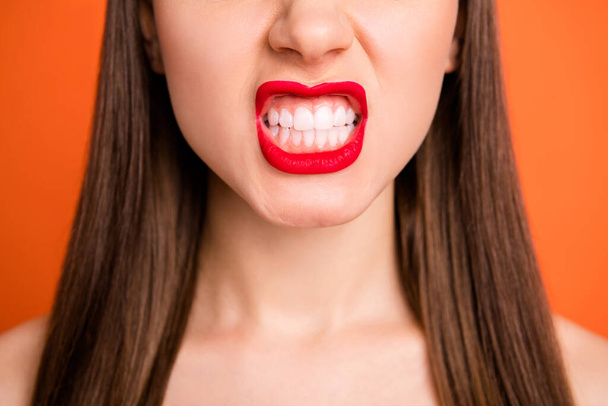 Closeup cropped photo of attractive lady grinning teeth bright red pomade amazing celebrity smile half face dentistry concept isolated vibrant orange color background - Foto, imagen
