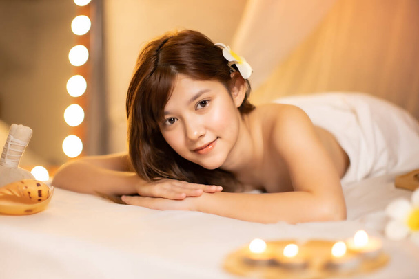Asian Beautiful, young and healthy woman in spa salon. Massage treatment spa room  . Traditional medicine and healing concept.closed up face. - Foto, imagen