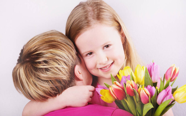 Feast of mother and daughter with tulips - Fotoğraf, Görsel