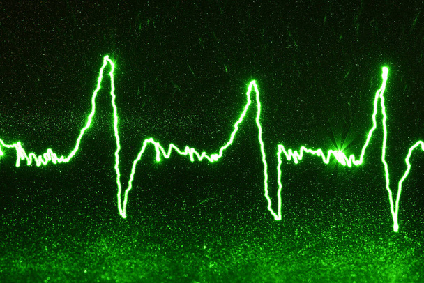 Latido verde en el fondo negro, cardiograma eléctrico
 - Foto, imagen
