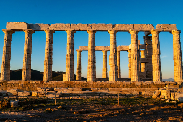 sunshine on ancient columns of parthenon in athens against blue sky  - Photo, Image