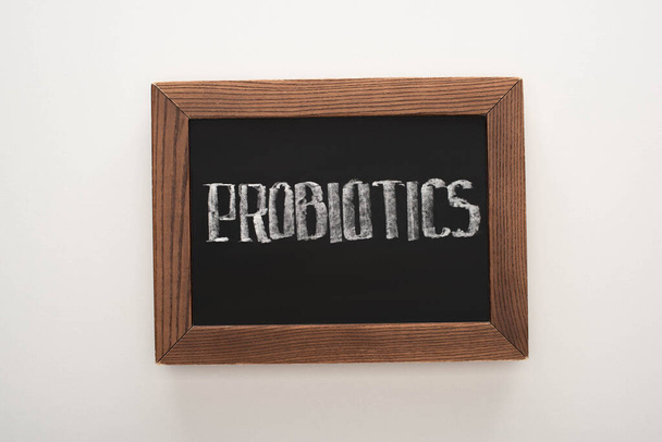 top view of chalkboard with probiotics lettering on white background - Photo, Image