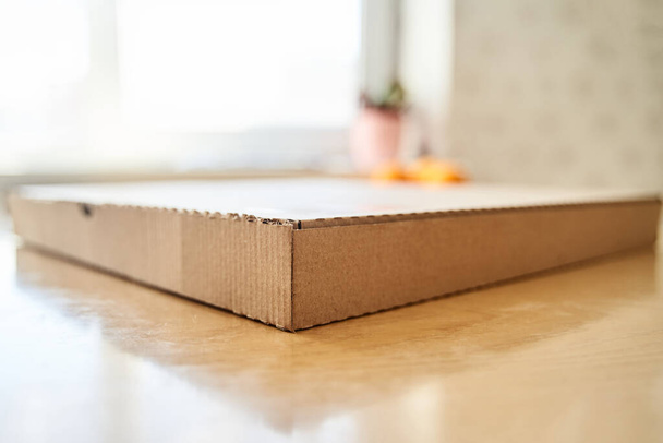 Пустой коричневый картон Бумажная коробка пиццы изолированы на столе
. - Фото, изображение