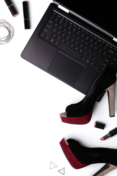 Laptop with shoes, lipstick and accessories isolated on white backgroud. Online shopping reuse clothing concept - Photo, Image