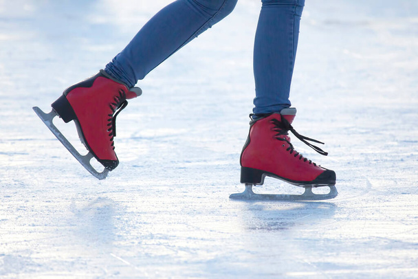 アイス・リンクの赤いスケート場に足を踏み入れると。趣味やレジャー。ウィンタースポーツ - 写真・画像