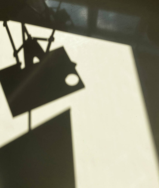 Shadow of artist easel on white surface - 写真・画像