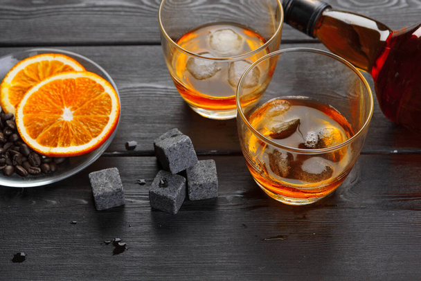 Whiskey and whiskey stones on a wooden table - Foto, Imagen