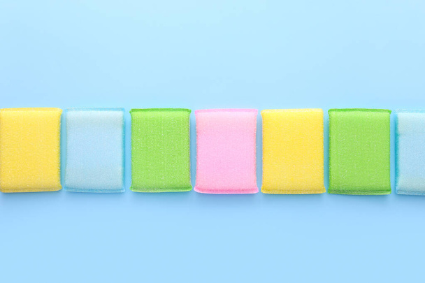 Colored kitchen sponges on blue background. Kitchen cleaning set - Photo, Image