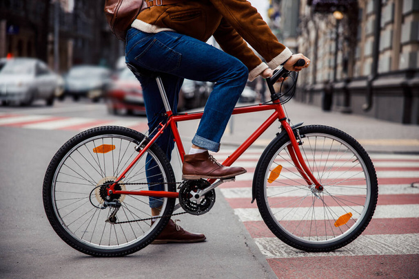 Legs of cycler on his bike in the street stock photo - 写真・画像