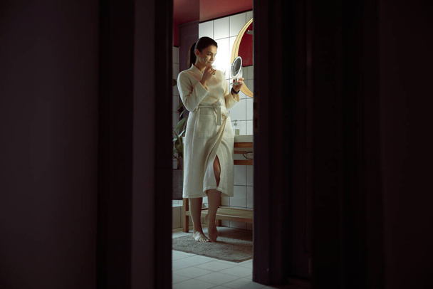 Woman taking care of face indoors stock photo - Valokuva, kuva
