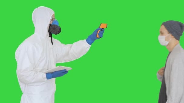 Operator check fever by digital thermometer on a Green Screen, Chroma Key. - Séquence, vidéo
