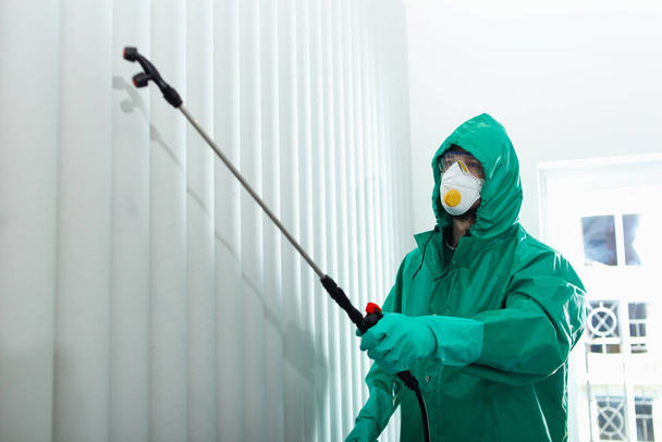 Specialist getting rid of insects by sanitizing surfaces stock photo - Фото, зображення