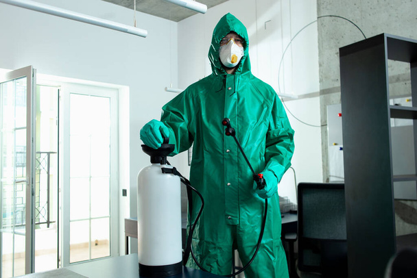 Responsible specialist demonstrating portable disinfectant tank stock photo - Foto, afbeelding