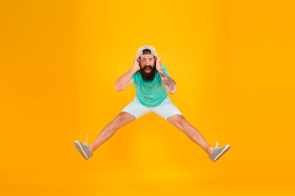 This is victory. brutal hipster jump high. his favorite song. mature dj full of energy. feel freedom. celebrating success. bearded man listen music. happy guy wear headphones. summer vacation party - 写真・画像