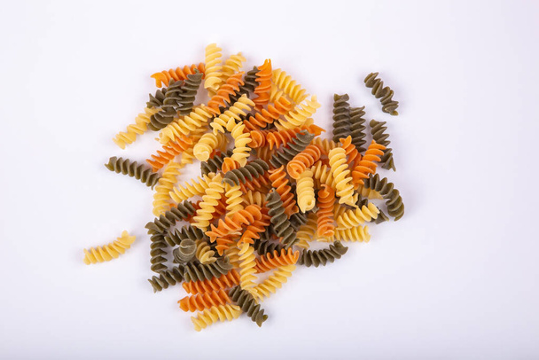 Close-up of colorful spiral pasta on white background - Photo, Image