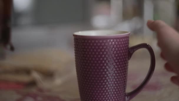 A woman pouring tea from a french press into a mug - Footage, Video
