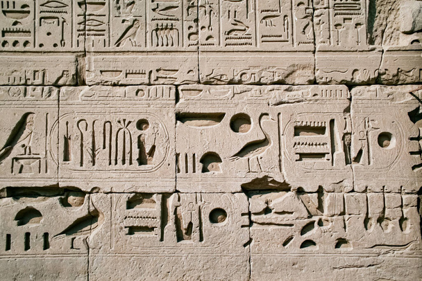 Luxor, Karnak Temple. Egyptian hieroglyphs on the wall of ancient temple - Photo, Image