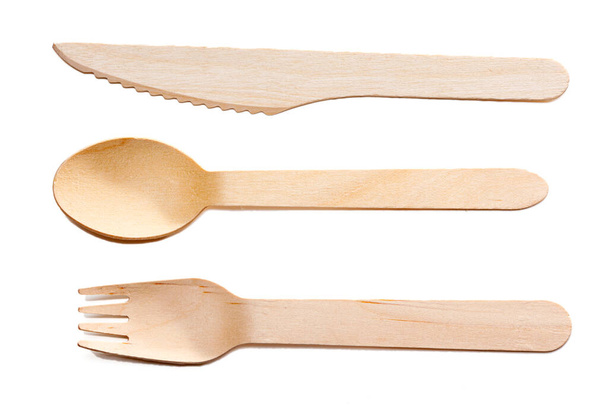 Wooden cutlery, disposable fork, spoon and knife isolated on white background. Timber biodegradable table setting for food made of natural eco recycle reusable material. - Photo, Image