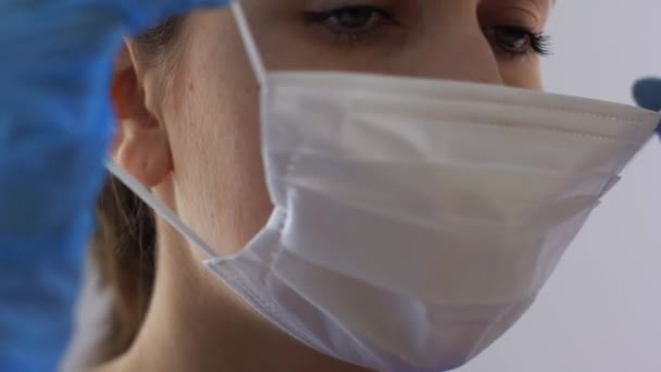 female doctor or nurse wearing medical face mask - Кадры, видео
