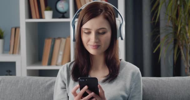 Woman using phone and headphones for listening music - Metraje, vídeo