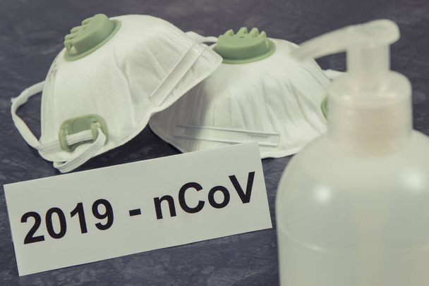Alcohol disinfectant and protective mask N95. Coronavirus covid-19 protection measures. Novel Chinese coronavirus outbreak. 2019-nCoV - Фото, изображение