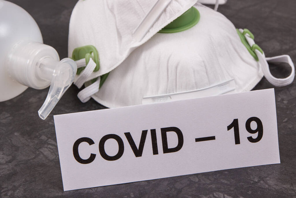 Disinfectant liquid with alcohol in bottle and protective mask N95. Disinfection hands and stop spreading outbreak coronavirus. Covid-19. 2019-nCoV - Photo, Image