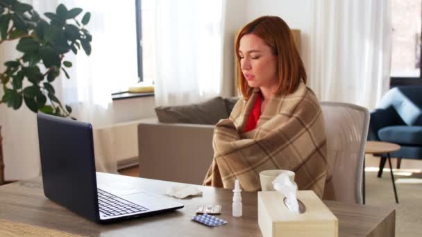 sick woman having video call on laptop at home - Video, Çekim