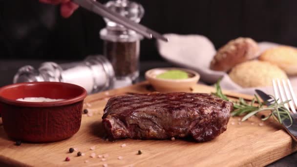 meat steak on a wooden board with sauce and spices - Video, Çekim