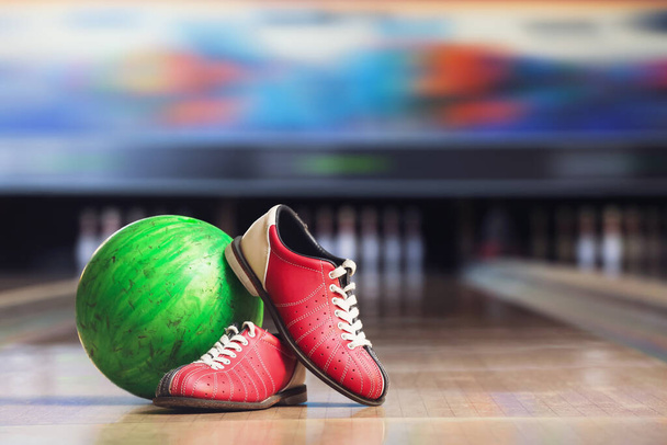 Shoes and ball on floor in bowling club - Foto, imagen