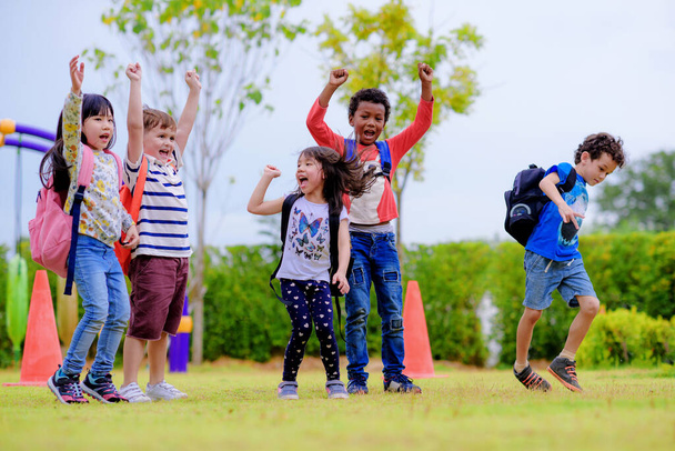 kids preschool kindergarten enjoy and happy jumping on the field of playground after school class is over to retuning home - Φωτογραφία, εικόνα