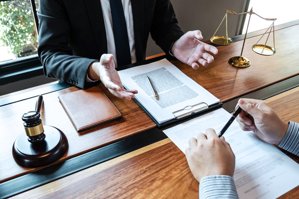 Professional male lawyer or counselor discussing negotiation legal case with client meeting with document contract in office, law and justice, attorney, lawsuit concept. - Photo, Image
